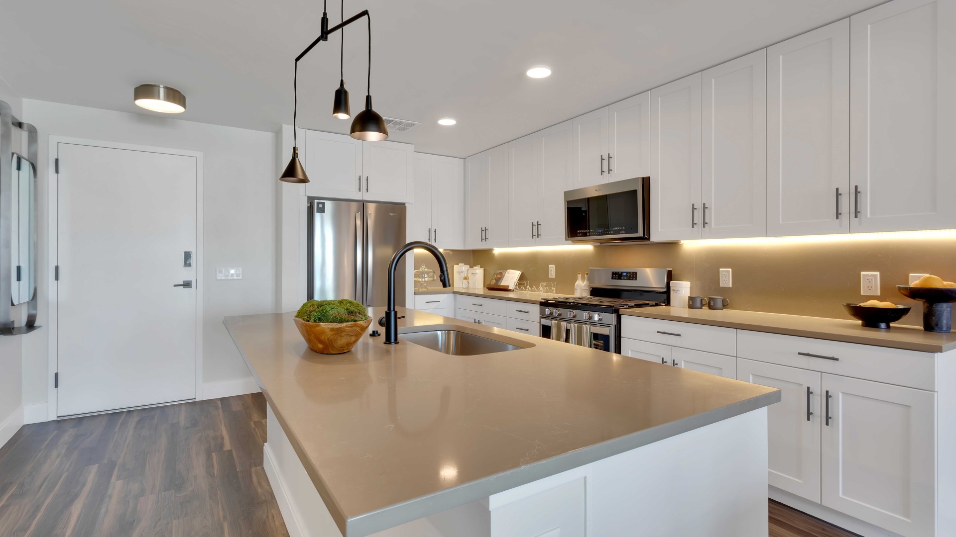 Modern kitchen with sleek cabinetry, stainless steel appliances, and stylish pendant lighting over a spacious island.	 Modern kitchen with sleek cabinetry, stainless steel appliances, and stylish pendant lighting over a spacious island.