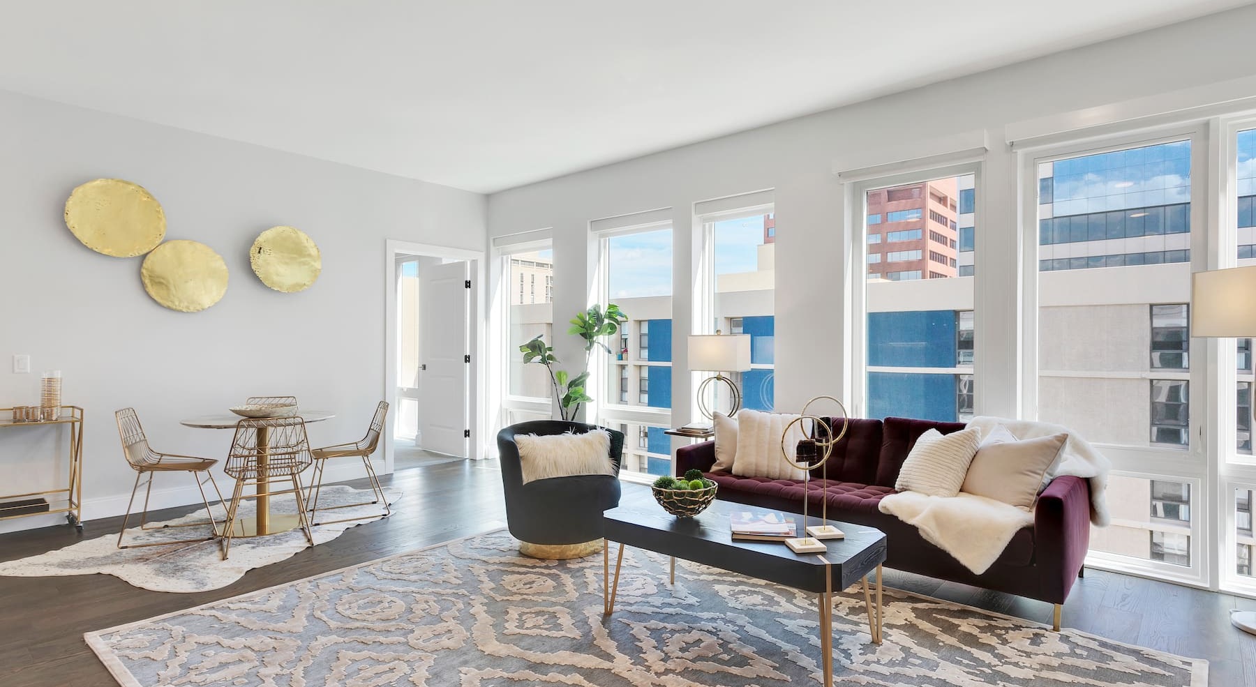 spacious living room with ample lighting and views of the courtyard