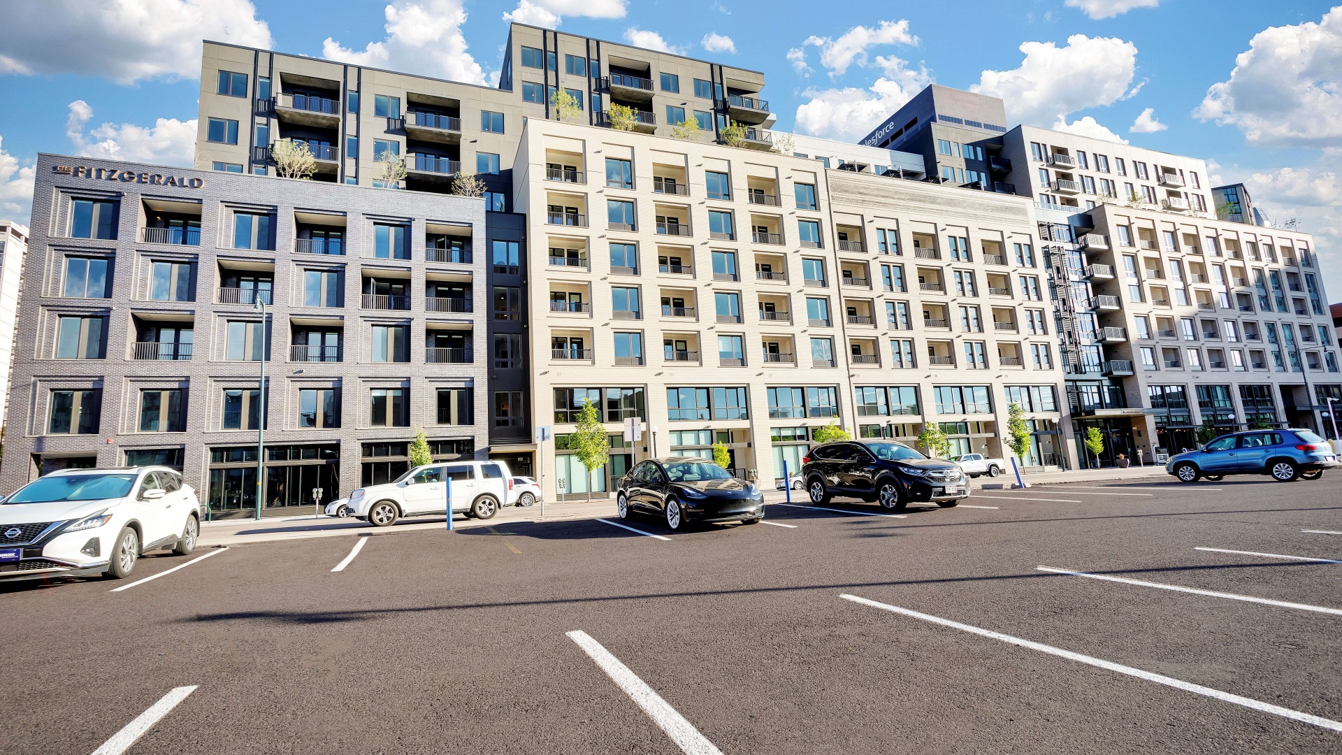 Modern urban apartment building featuring sleek architecture with large windows and balconies, set against a bright blue sky.	 Modern urban apartment building featuring sleek architecture with large windows and balconies, set against a bright blue sky.
