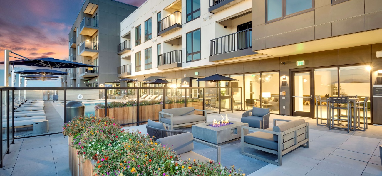 Luxurious apartment complex with modern outdoor seating and vibrant garden beds at sunset, showcasing elegant balconies and stunning architecture.	 Luxurious apartment complex with modern outdoor seating and vibrant garden beds at sunset, showcasing elegant balconies and stunning architecture.