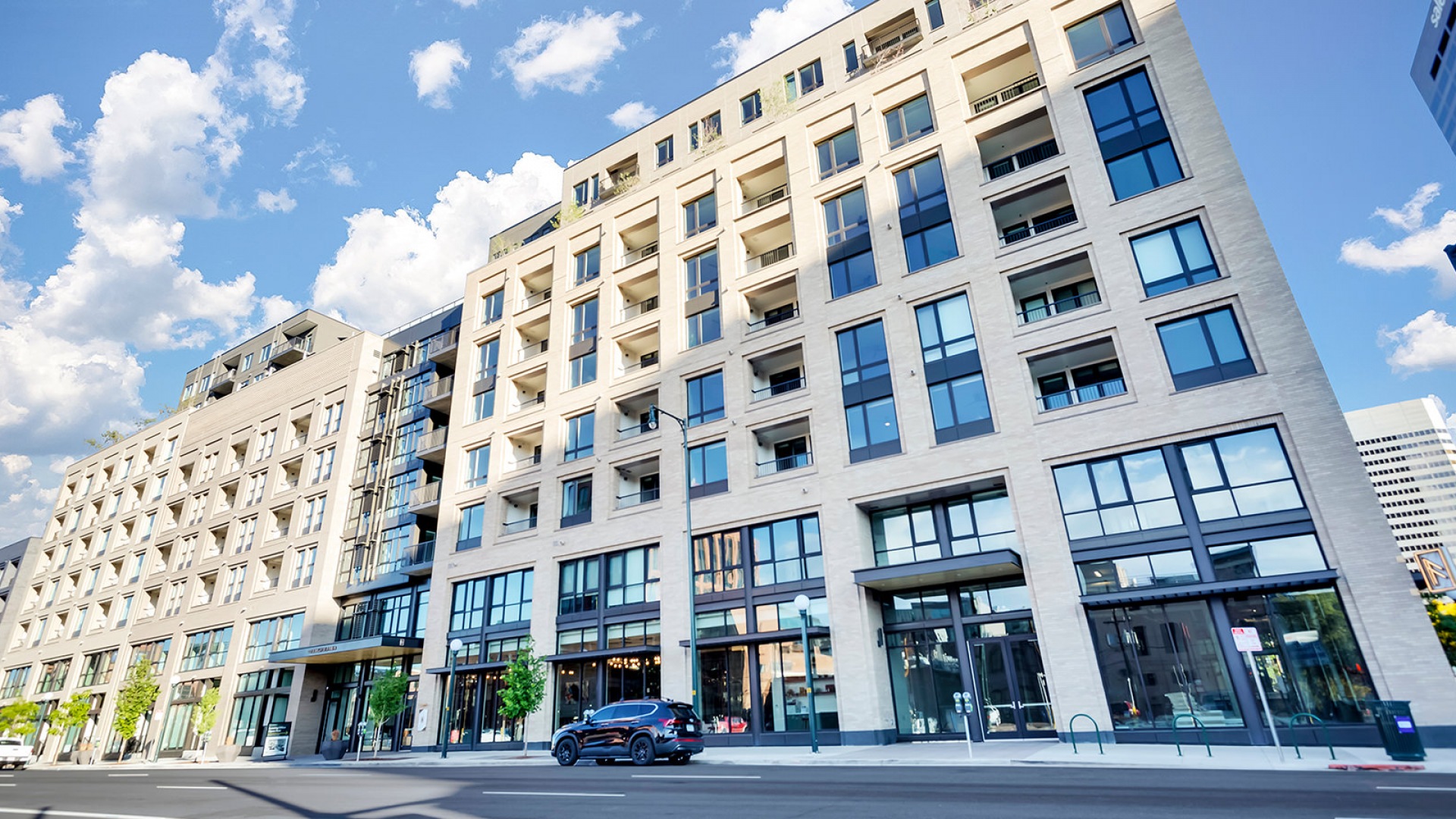 Modern apartment building exterior with sleek glass windows, inviting balconies, and stylish entrance in a sunny urban setting.	 Modern apartment building exterior with sleek glass windows, inviting balconies, and stylish entrance in a sunny urban setting.